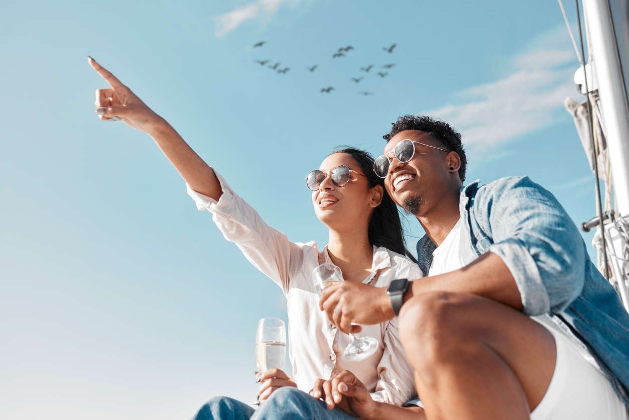 Couple travel, champagne drink and date on yacht, wine on wedding holiday in Greece and happy in celebration of marriage on cruise vacation. Man and woman relax with glass of alcohol on boat filming locations while cruising
